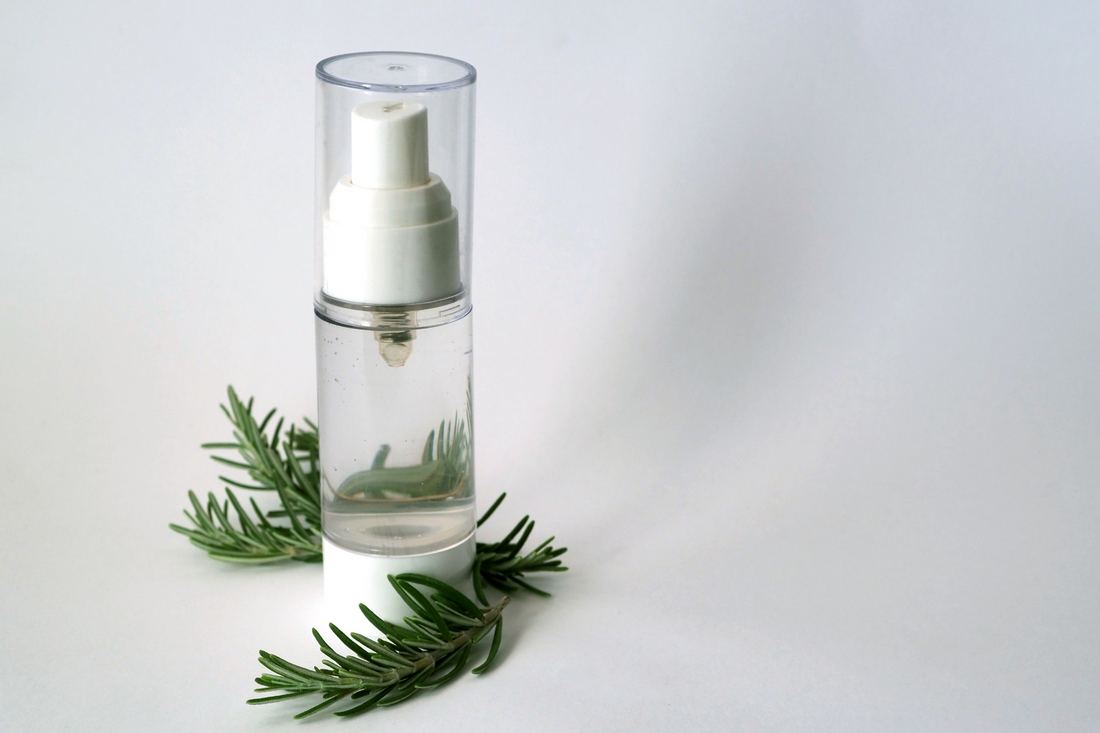 a bottle of natural toner with several green branches