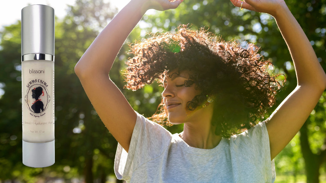 A woman with dark skin enjoying the sun in a natural environment with Gemma Crema Anti-Aging Serum