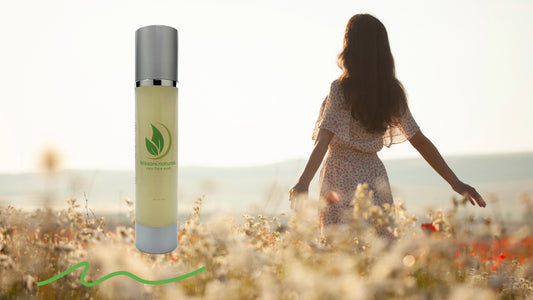 A woman in a beautiful field of tall grass and a bottle of blissani naturals vegan face wash
