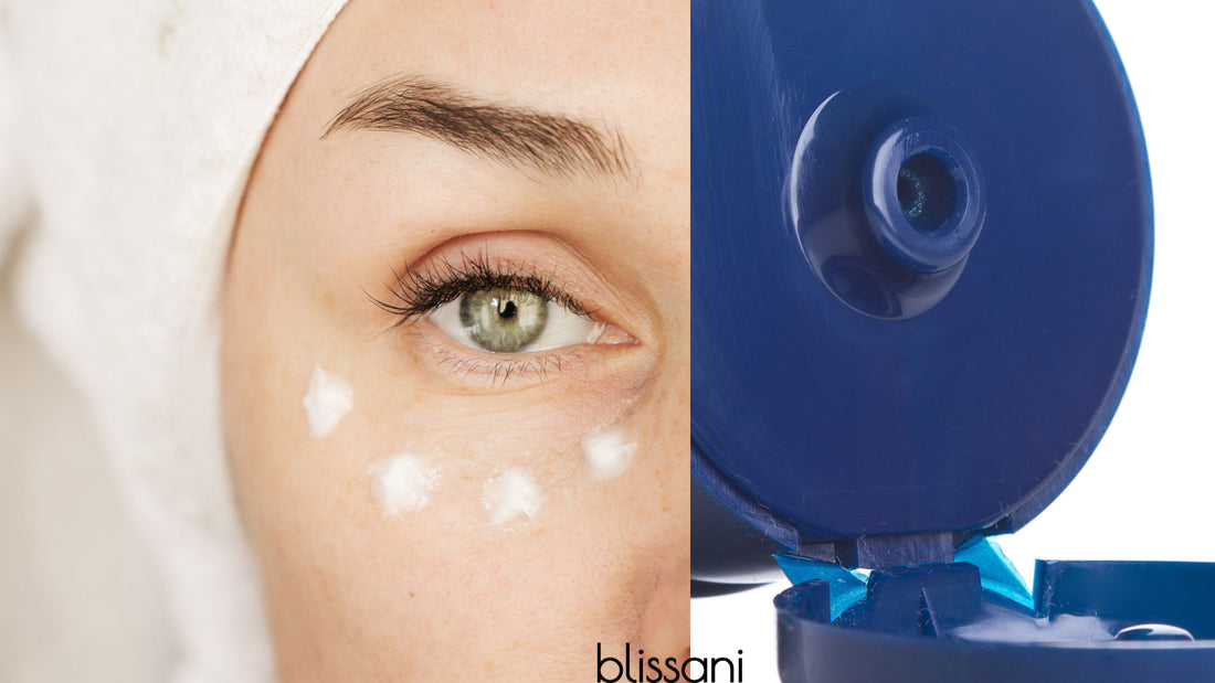 A woman in her 40's putting with wrinkle cream under eye next to a tube of skin cream