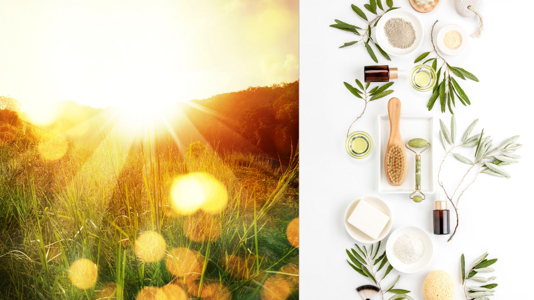 A bright orange sunrise coming up over a mountain next to a variety of natural skincare ingredients and tools