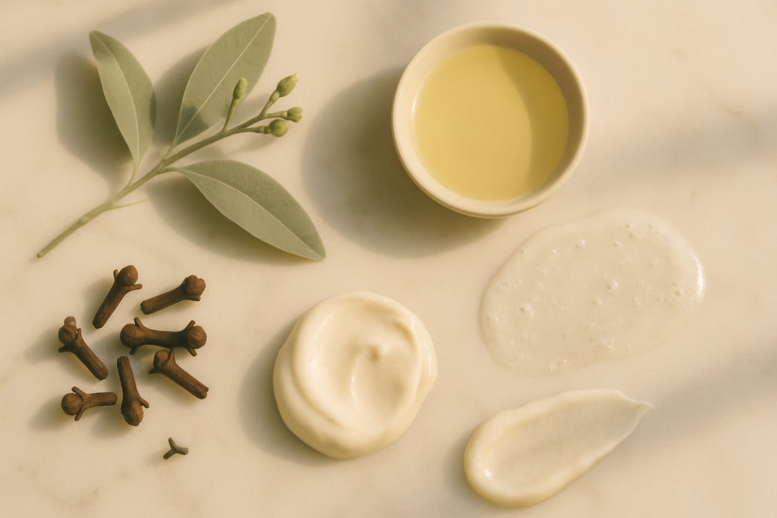 Dried clove buds and amber essential oil dropper on linen — clove oil for acne natural skincare ingredient